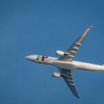 TAP Air Portugal airplane flying in clear blue sky